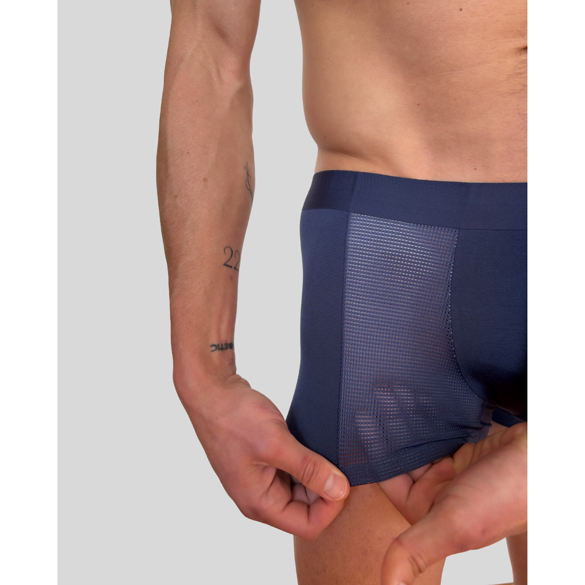 Model wearing SilkCut navy trunks showing ergonomic pouch and waistband